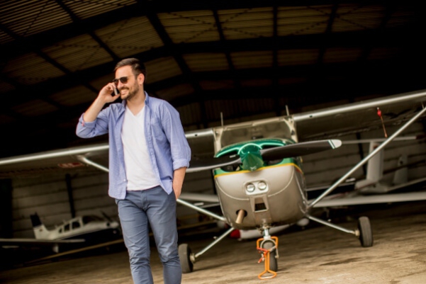 Private pilot standing by his plane